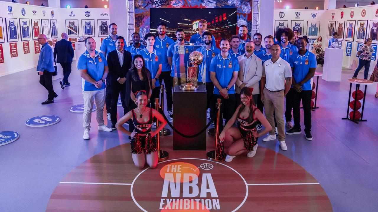 Brisbane Bullets players stand with the Larry O'Brien Trophy