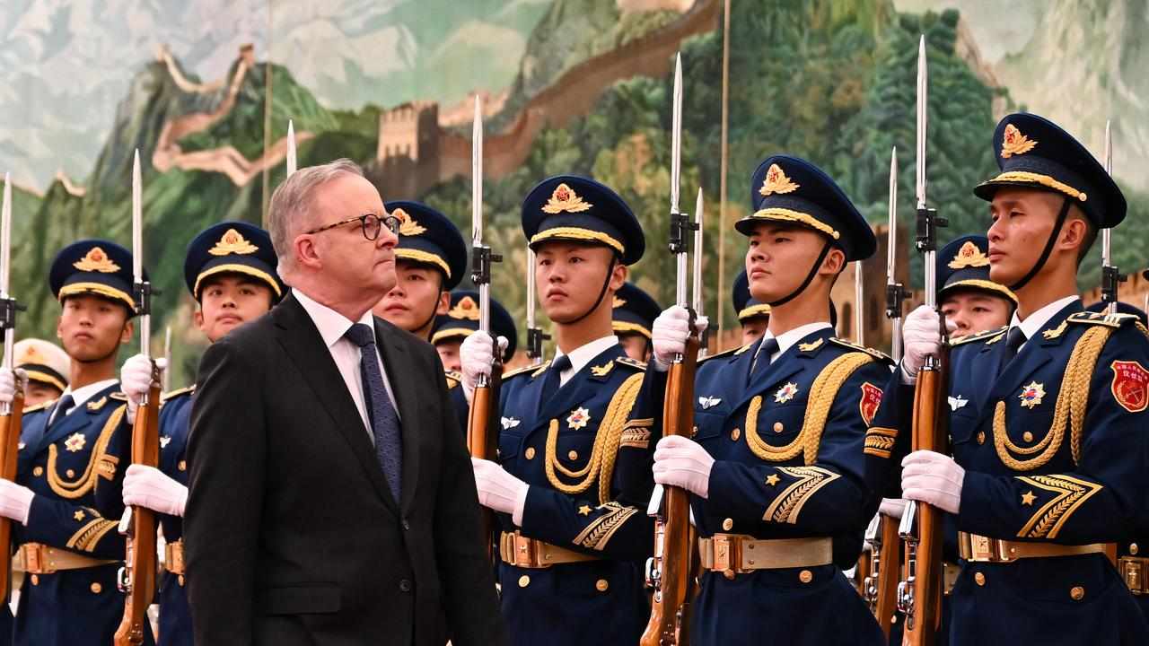 Mr Albanese inspects a guard of honour in Beijing.