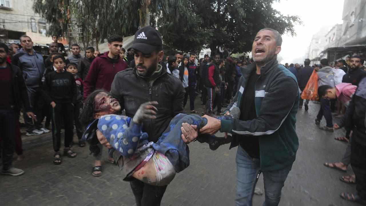 Palestinians evacuate survivors of an Israeli bombardment in Rafah
