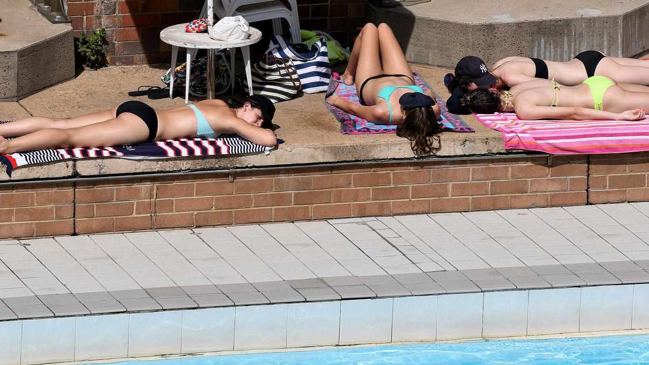 People lying in the sun at North Sydney Olympic Pool