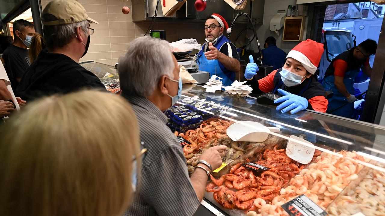Customers buying seafood for at Queen Victoria Market in Melbourne
