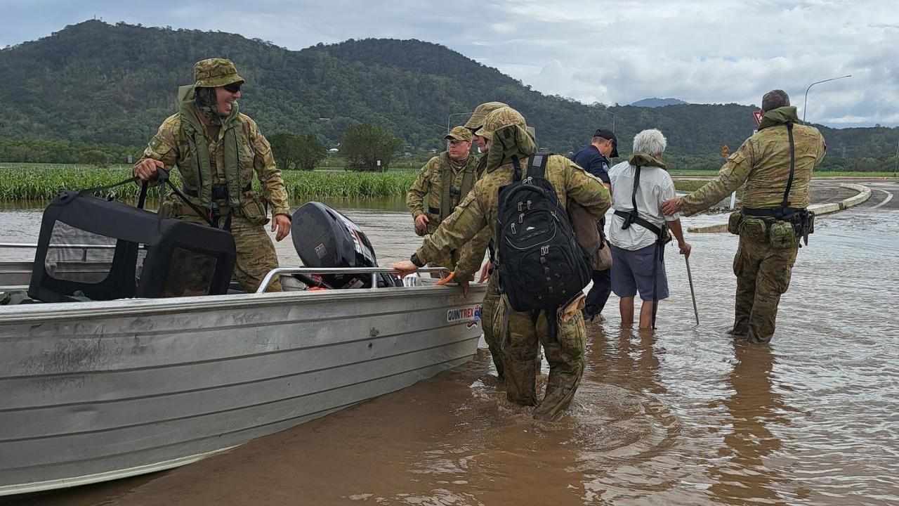 Australian Army soldiers help relocate stricken residents.