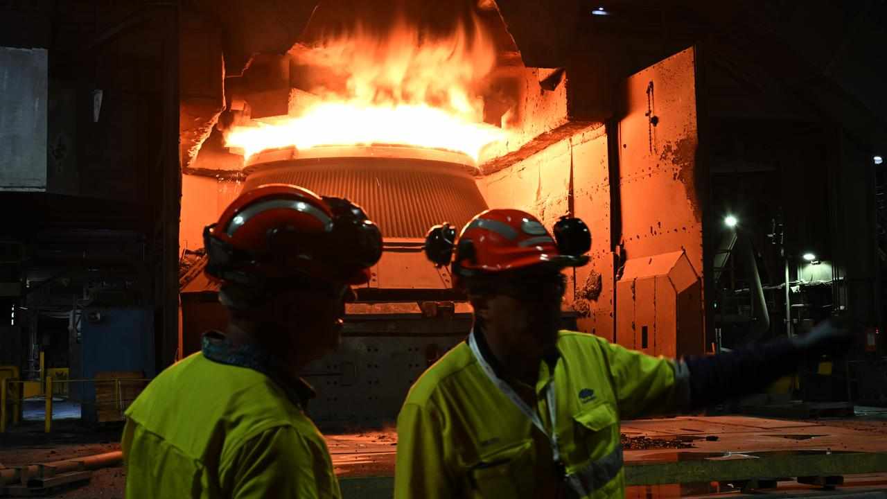 Workers and molten steel at a factory