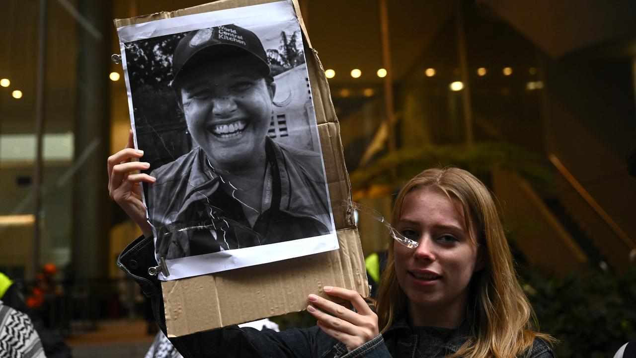 A protester with a photo of Zomi Frankcom