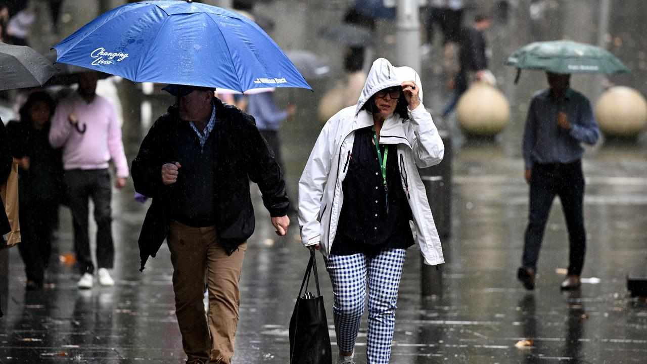 People walk through rain in central Sydney.
