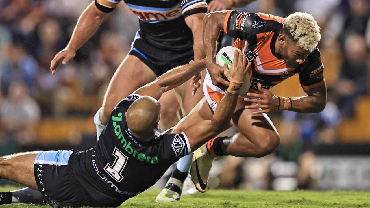 Will Kennedy of the Sharks attempts to tackle Tigers' Api Koroisau.
