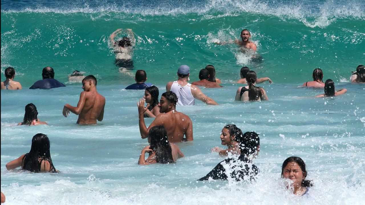 People cooling off in the ocean.