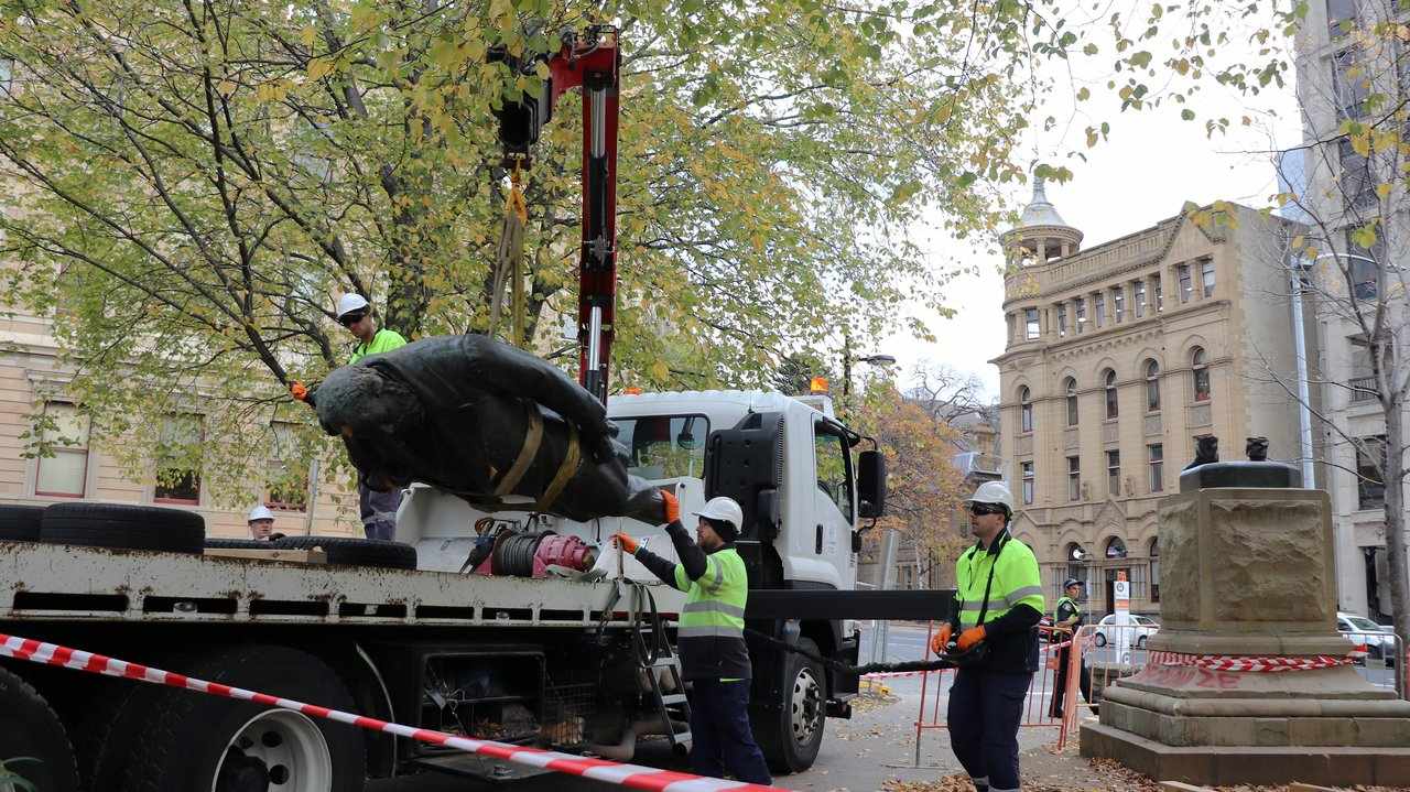 Council workers remove the statue of William Crowther in Hobart