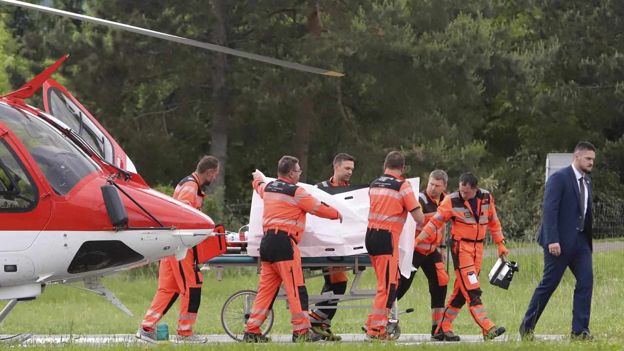 Rescue workers wheel Slovak Prime Minister Robert Fico on a stretcher