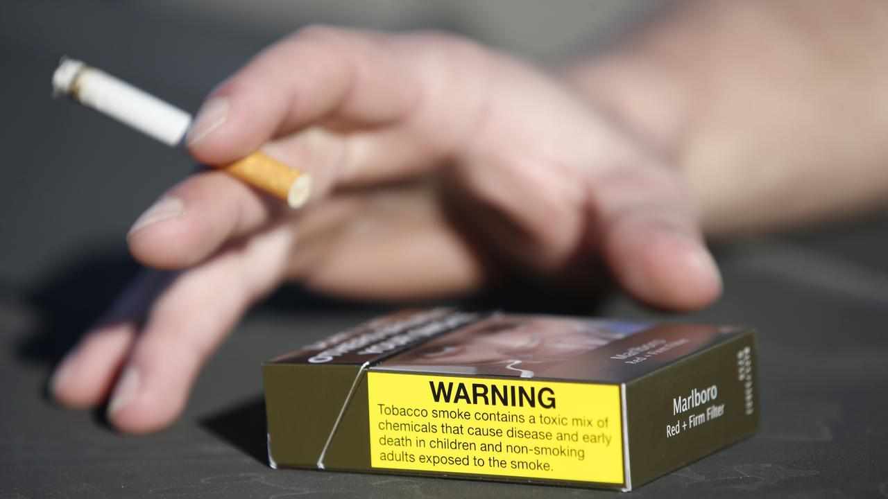 a burning cigarette and packet