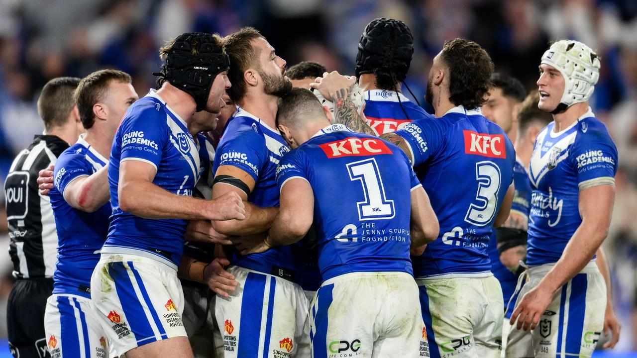 Bulldogs players celebrate a try.