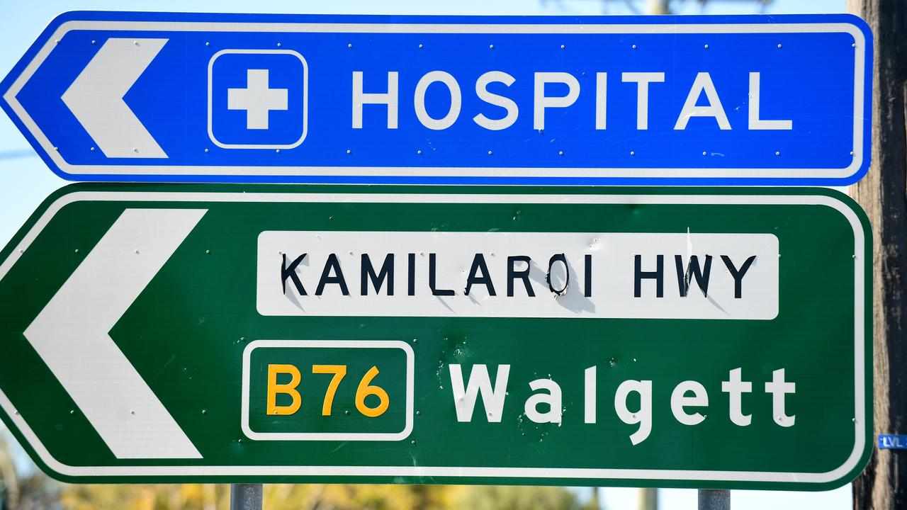 A hospital sign above a sign to Walgett.